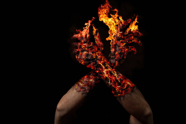 Burning hands on a black background. Combustion of the human term. - Photo, Image