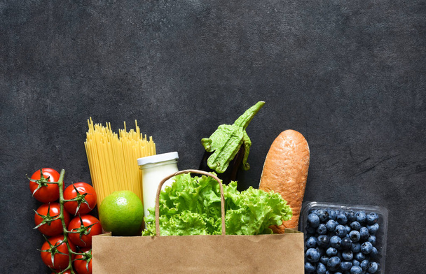 Shopping in a paper bag: vegetables, milk, berries, nuts - 写真・画像