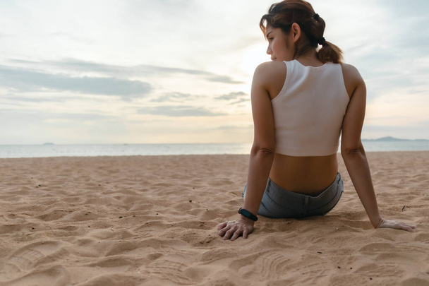 Woman sit on the beach in summer time. - Фото, зображення