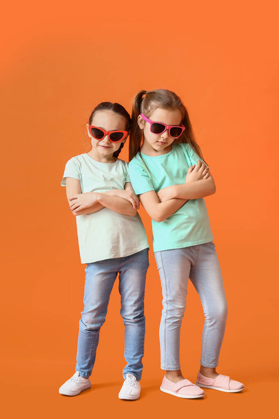 Cute little sisters on color background - Photo, Image