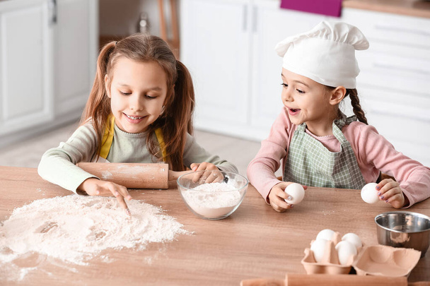 Cute little sisters cooking in kitchen - Photo, Image