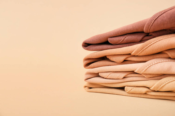 Stack of baby clothes on color background, closeup - Photo, Image