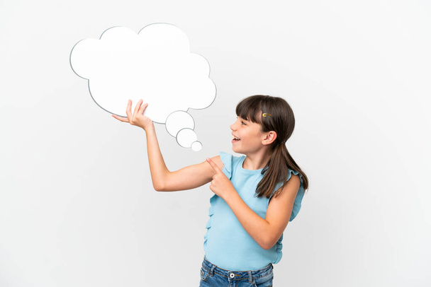 Little caucasian kid isolated on white background holding a thinking speech bubble and pointing it - Foto, Imagem