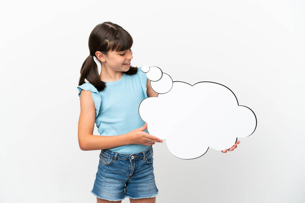 Little caucasian kid isolated on white background holding a thinking speech bubble - Photo, Image