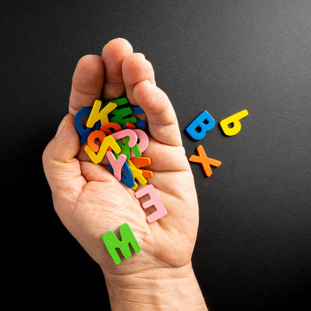 some colored letters in the palm of the hand - Photo, image