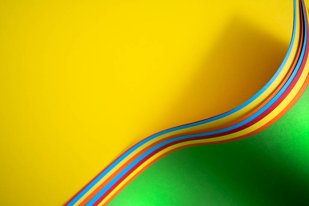 Some colored sticks on a yellow surface as the gay pride symbol - Фото, изображение