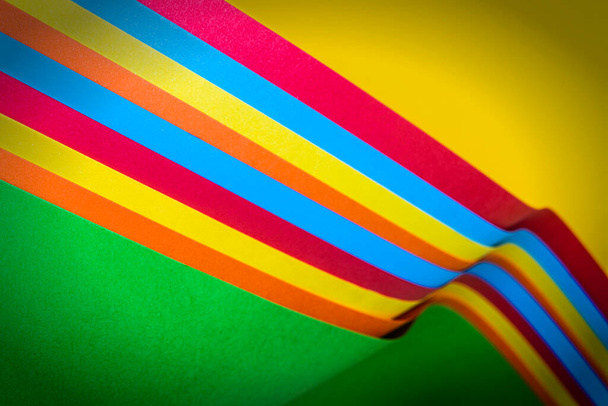 Some colored sticks on a yellow surface as the gay pride symbol - Fotografie, Obrázek
