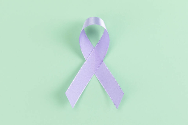 purple ribbon on mint color background - Foto, Imagem