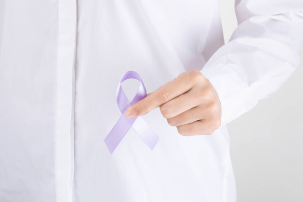 person with white shirt holding purple ribbon - Photo, image