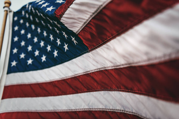 An American flag on the flagpole waving in the wind - Φωτογραφία, εικόνα