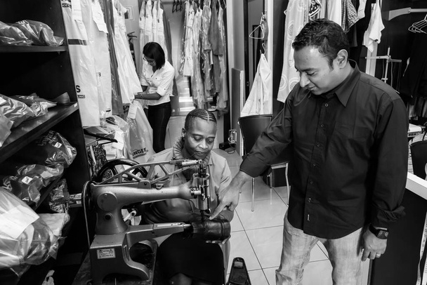 JOHANNESBURG, SOUTH AFRICA - Jan 06, 2021: Two men shopping for jeans in an up-market store - Fotó, kép