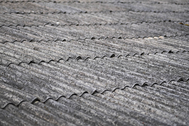 A gray roofing made of old Soviet-era asbestos slate - Photo, Image