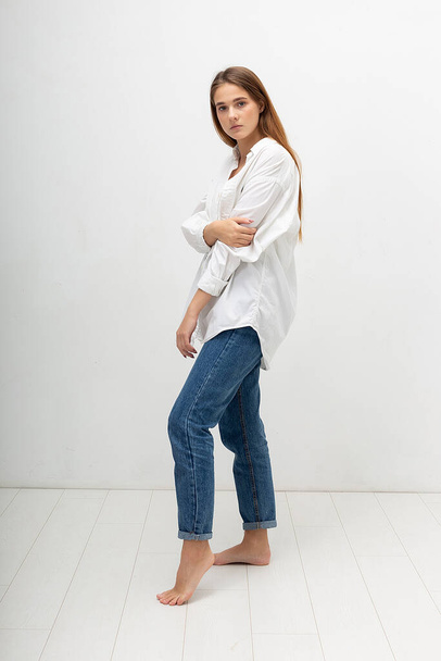young attractive caucasian woman with long brown hair in shirt, blue jeans - Photo, image