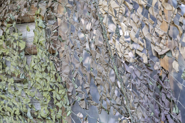Khaki military camouflage net for hiding of vehicles and secret objects - Photo, Image