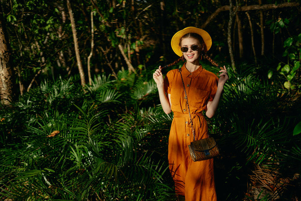 woman tourist in hat and sunglasses in summer on jungle island - Photo, Image