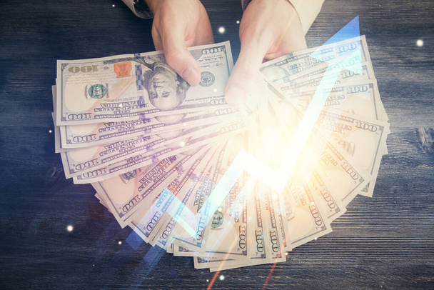 Multi exposure of arrows drawing hologram and USA dollars bills and man hands. Growth concept. - Valokuva, kuva