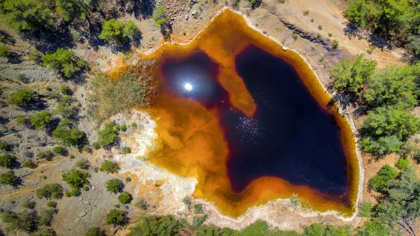 Acidic red lake in place of abandoned open pit copper mine near Kinousa, Cyprus. Aerial view from directly above - Photo, Image