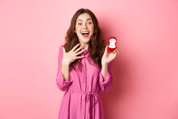Excited young woman showing engagement ring, getting married, smiling happy, talking about wedding day, receive marriage proposal. Copy space - Foto, Imagen