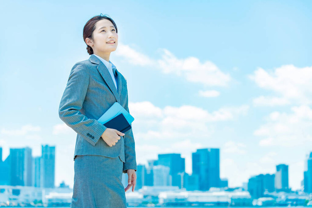 City center, blue sky and asian young business woman  - Foto, afbeelding