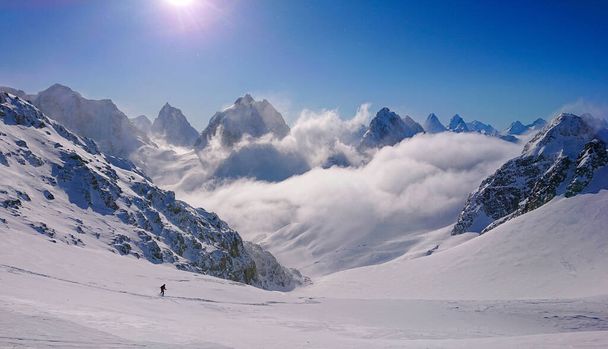 Unrecognizable tourist skis down an ungroomed slope high in the Canadian Rockies - Photo, Image