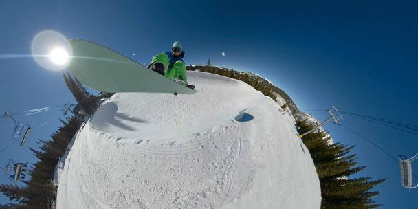 SELFIE: Pro male snowboarder catches big air while doing tricks in a halfpipe - Foto, Bild
