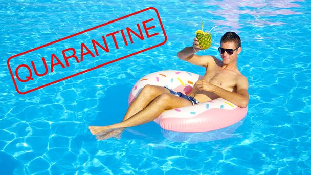 CLOSE UP: Man on cool spring break enjoys his pineapple drink while in a pool - Photo, Image