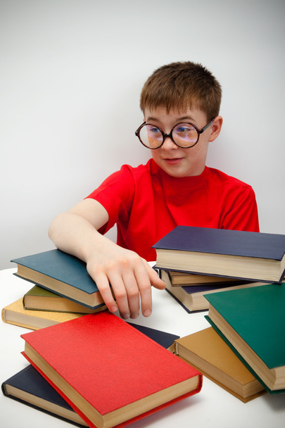 sproeterig jongen in ronde bril en een boek - Foto, afbeelding