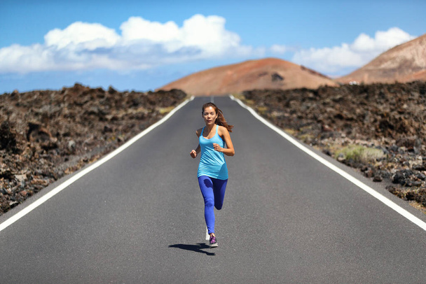 Athlete runner fit woman running on road in nature landscape. Fitness active healthy lifestyle Asian girl sprinting fast outside. Sport exercise concept. - Foto, Bild