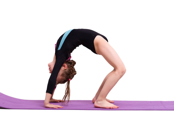 Cute child girl making Gymnastic exercises against white background. - Foto, Imagem