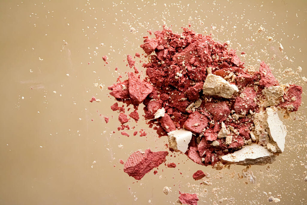 Crushed cosmetics, mineral organic eyeshadow, blush and cosmetic powder isolated on golden background, makeup and beauty banner, flatlay design - Photo, Image