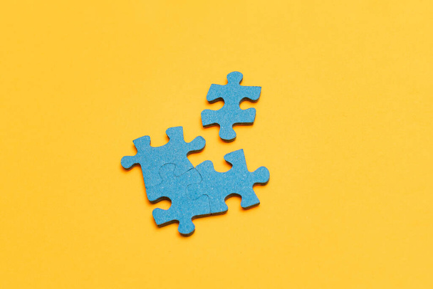 Puzzle Pieces on Yellow Background - Фото, изображение