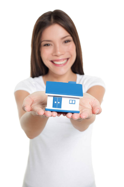 Home owner of first house holding small house toy on hands for real estate mortgage, loan, insurance concept - Foto, Imagem