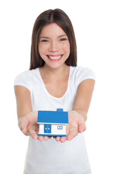 Homeowner buying first house happy Asian woman holding hands real estate house smiling showing miniature toy for home insurance protection concept - Valokuva, kuva