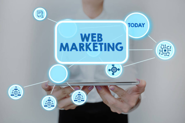 Text sign showing Web Marketing. Business idea Electronic commerce Advertising through internet Online seller Lady In Uniform Standing Holding Tablet Showing Futuristic Technologies. - Φωτογραφία, εικόνα