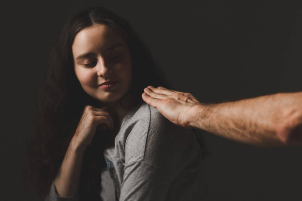 Relationship concept. Male hand on the shoulder of a young girl.  - Foto, immagini