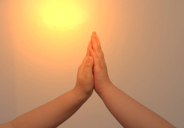 Kid hands high five touch together with sun flare in business concept - Φωτογραφία, εικόνα