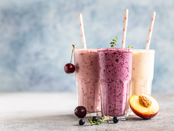 Colorful various smoothie or milkshake with assorted ingredients served in glasses with straw. Healthy food concept. Selective focus. - 写真・画像