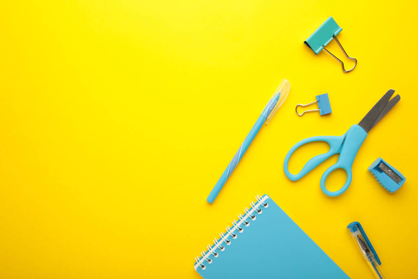 Blue school supplies on yellow background. Back to school concept. Top view. - Zdjęcie, obraz
