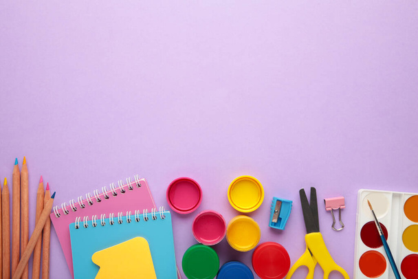 School supplies on purple background. Back to school concept. Top view. - Photo, Image