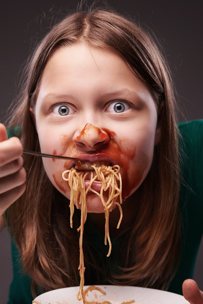 Teen girl furiously eating  - Foto, afbeelding