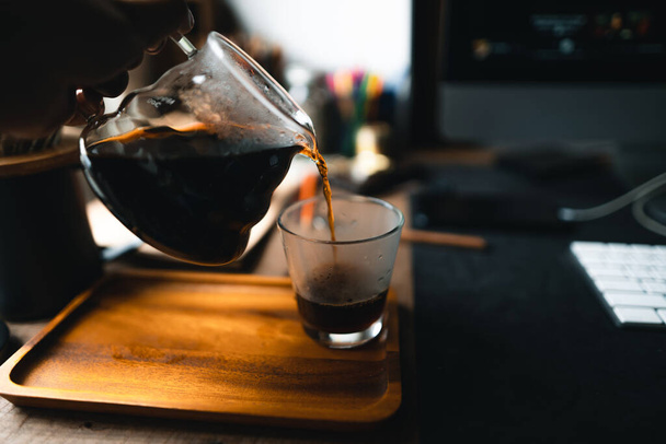 hot water into coffee dripper above glass jar. - Valokuva, kuva