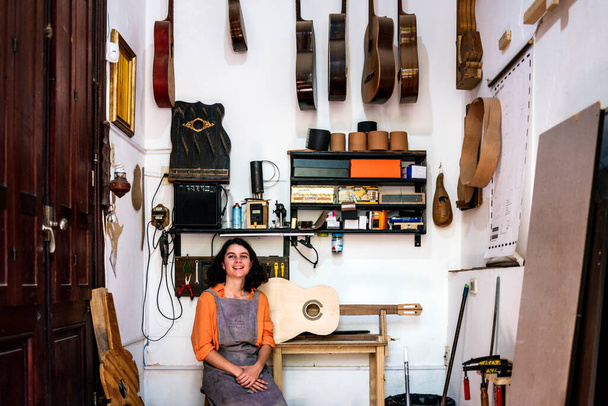 woman luthier making guitars in her musical instrument workshop - Valokuva, kuva
