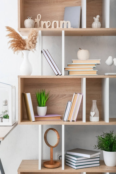 Stylish shelf unit with books and decor in room, closeup - Photo, Image