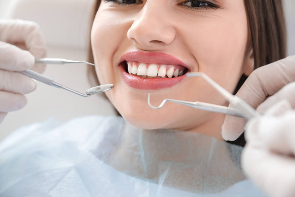 Young woman visiting dentist in clinic, closeup - Photo, Image