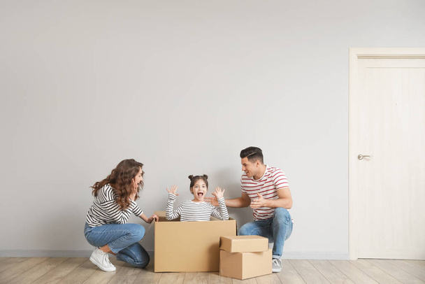 Happy family with moving boxes in their new house - Photo, Image