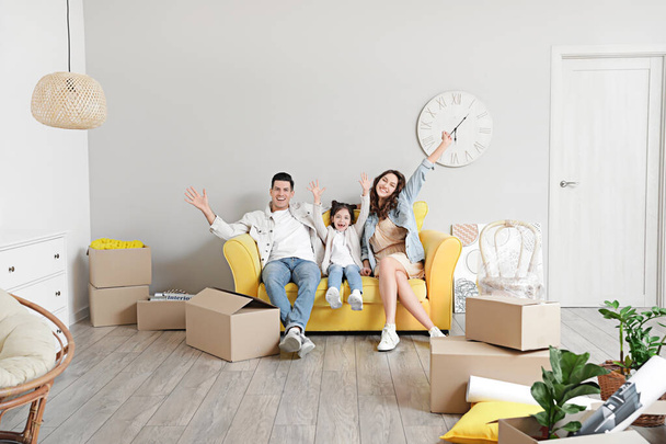 Happy family with moving boxes in their new house - 写真・画像