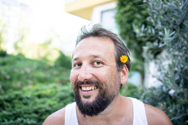 Funny man with flower in nose laughing - Fotografie, Obrázek