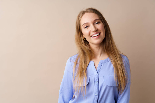 Portrait of beautiful smiling young woman in studio - Photo, image