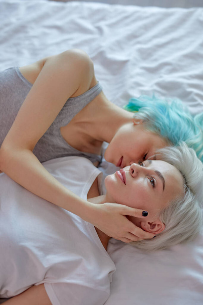 LGBT concept. top view Two beautiful sexy lesbian women on bed, hugging and kissing - Φωτογραφία, εικόνα