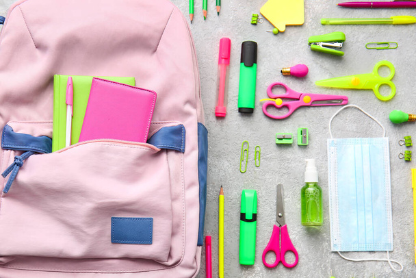 School backpack and stationery on light background - Photo, Image